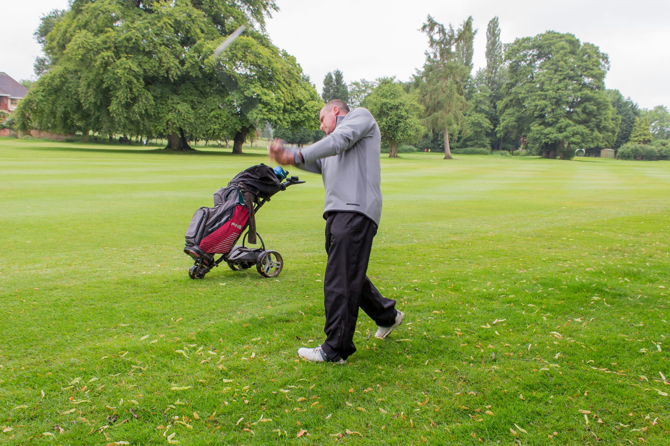 Man striking golf ball at a Katharine House Hospice charity golf event.