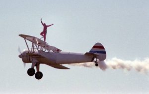 white plane Person on top of plane