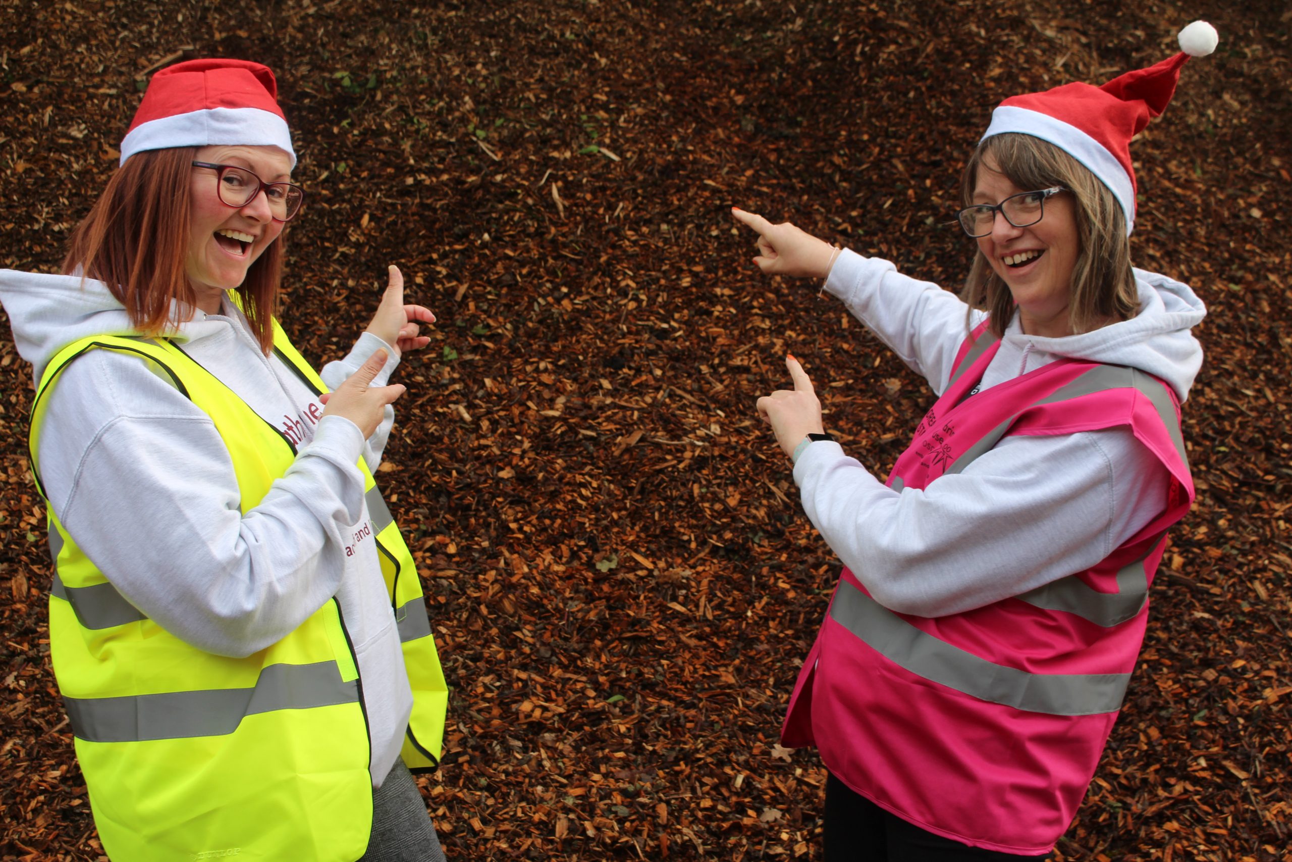 christmas-trees-recycled-2022-katharine-house Community and Partnerships Fundraiser Andrea Pugh (right) and Fundraising Coordinator Lyndsey Howard pictured infront of a pile of mulch made from recycled Christmas trees.