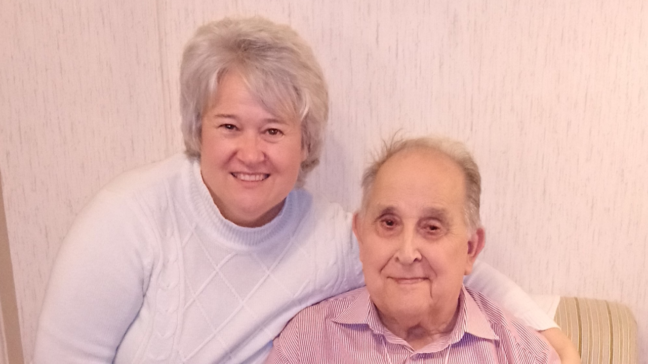 Jane Litchfield pictured next to her father; both are smiling at the camera.