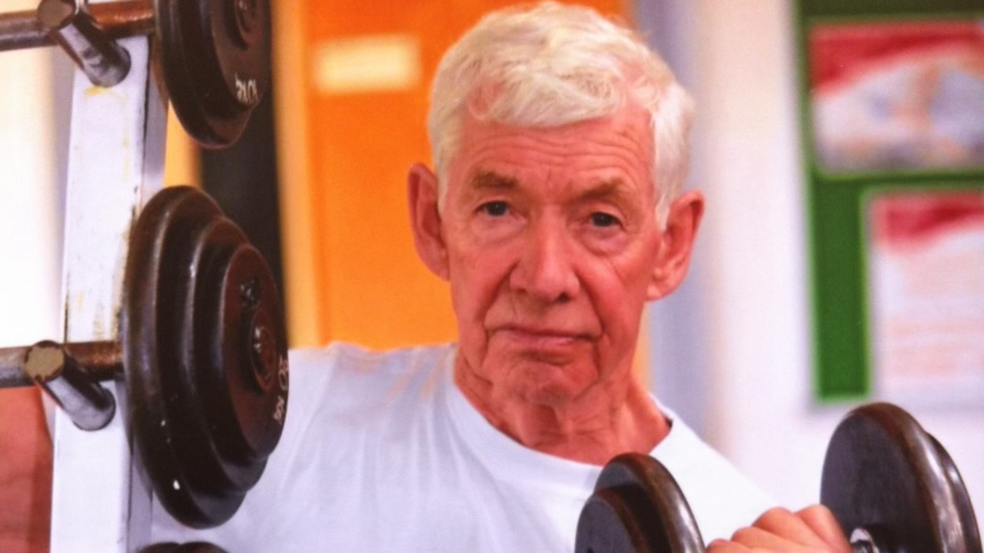 Close up of Patrick Harvey lifting weights.