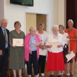 Volunteers receiving awards for their service.