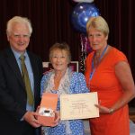 Volunteers receiving awards for their service.