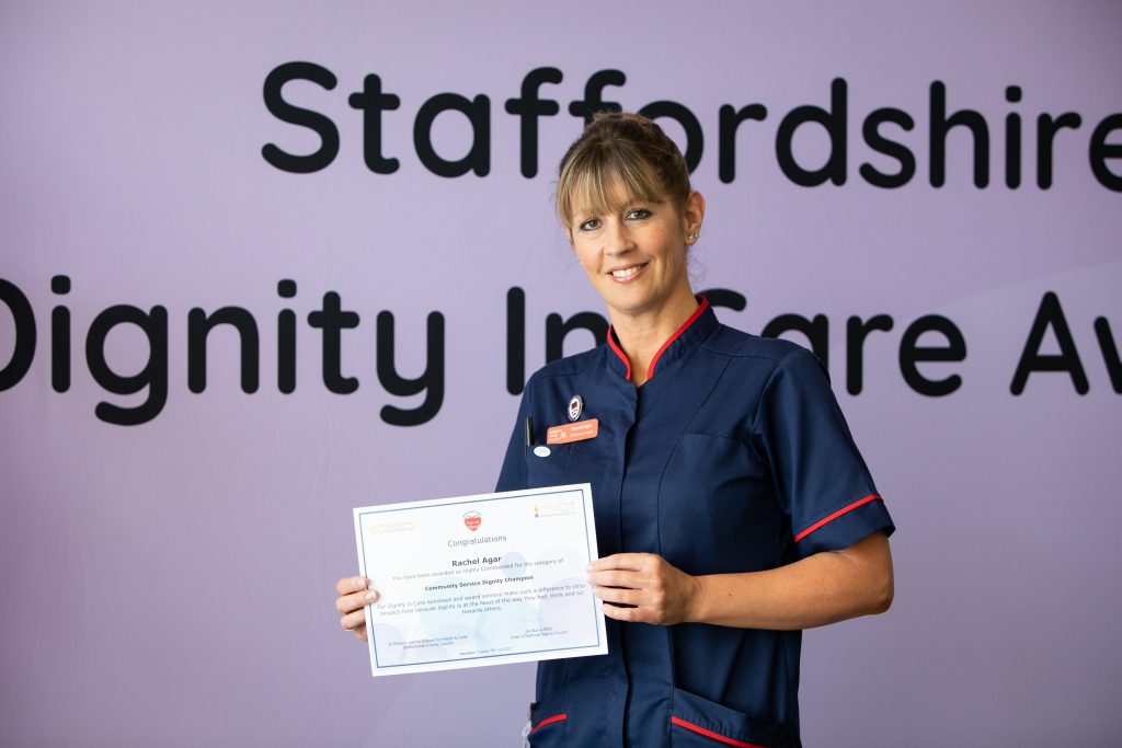 Rachel Agar smiling with her certificate.