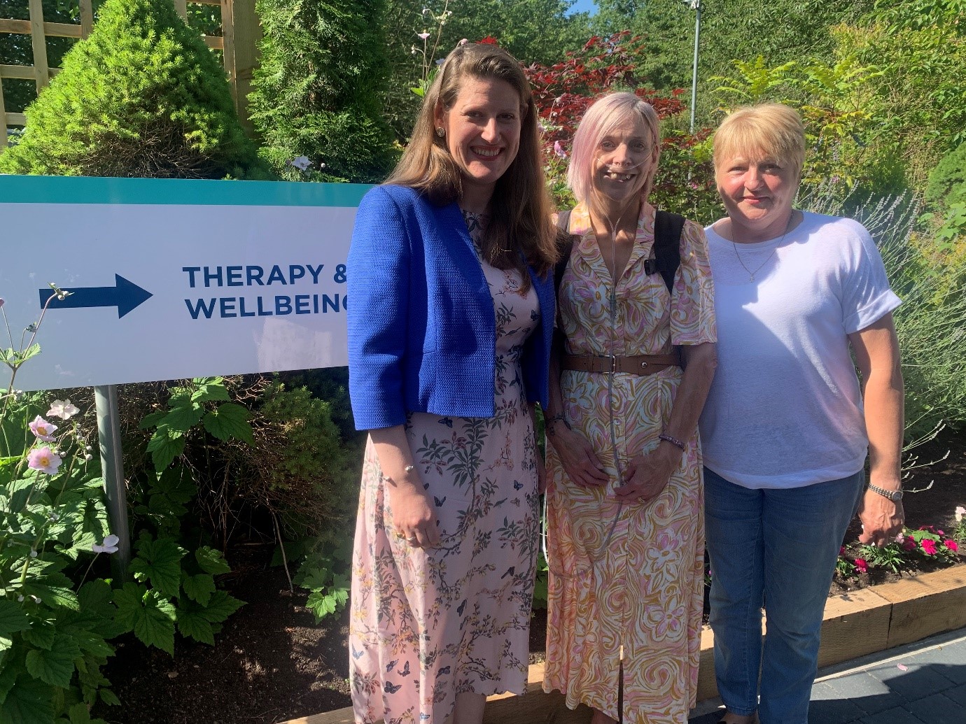 Stafford MP Theo Clarke smiles with patients of Katharine House Hospice.