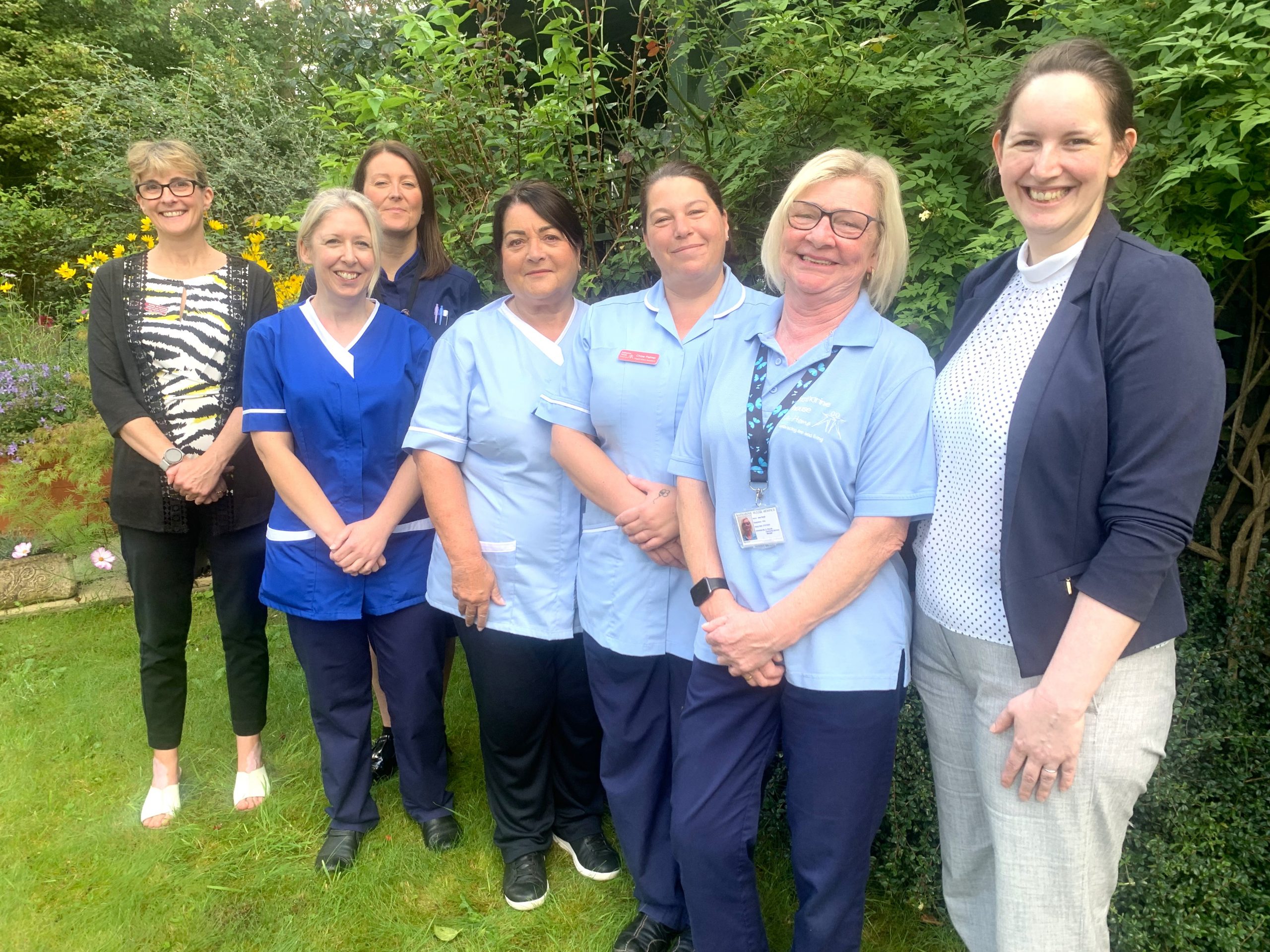 Lead nurse, Carina, smiles with the nursing team.