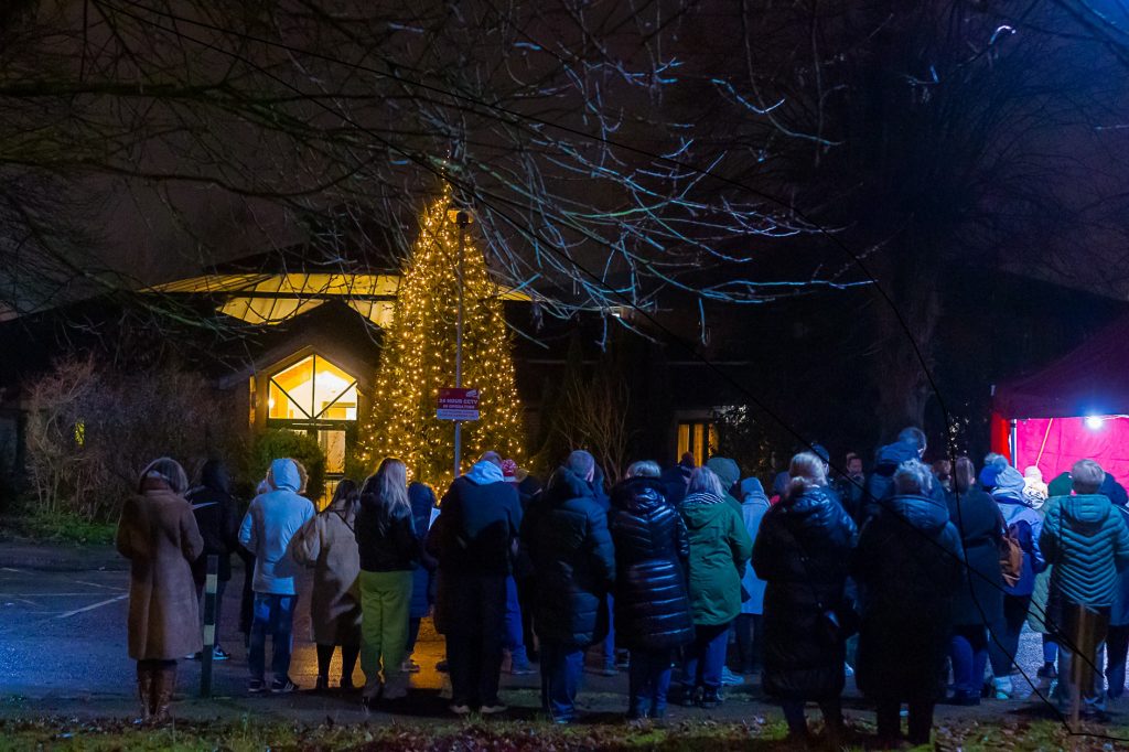 People stood around a Christmas tree outside the hospice