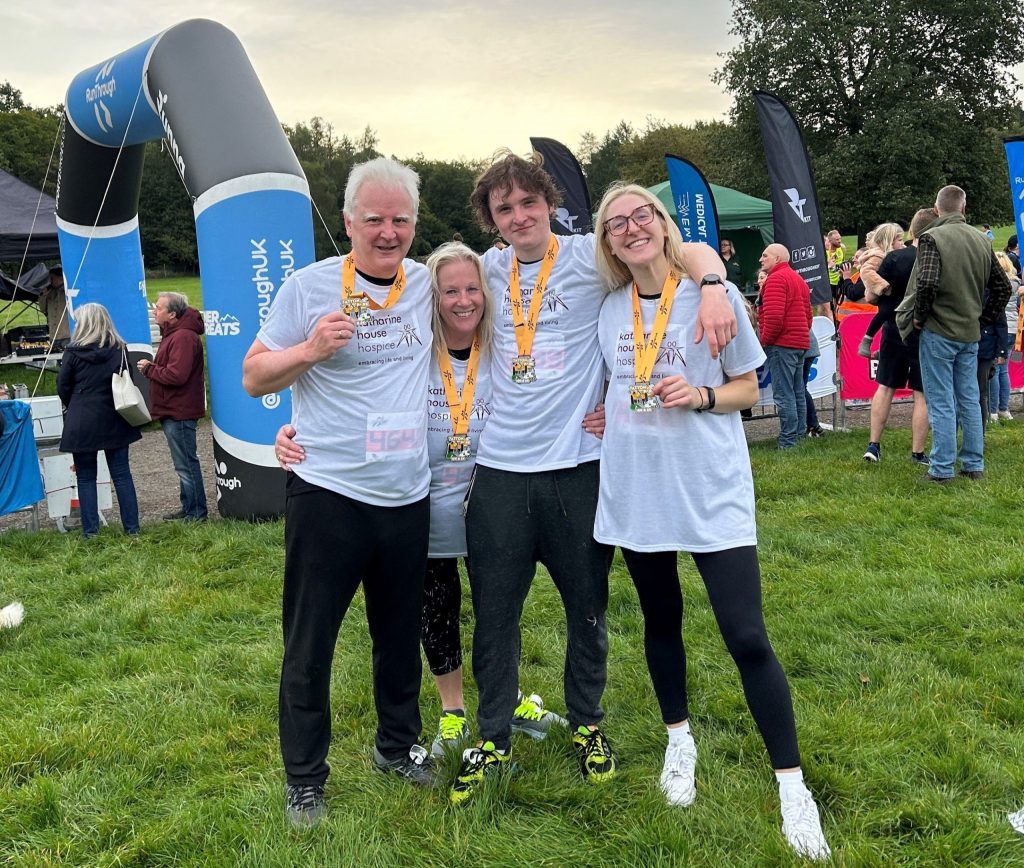 Richard and his family smiling together with their medals after completing the Tatton Park 5K.