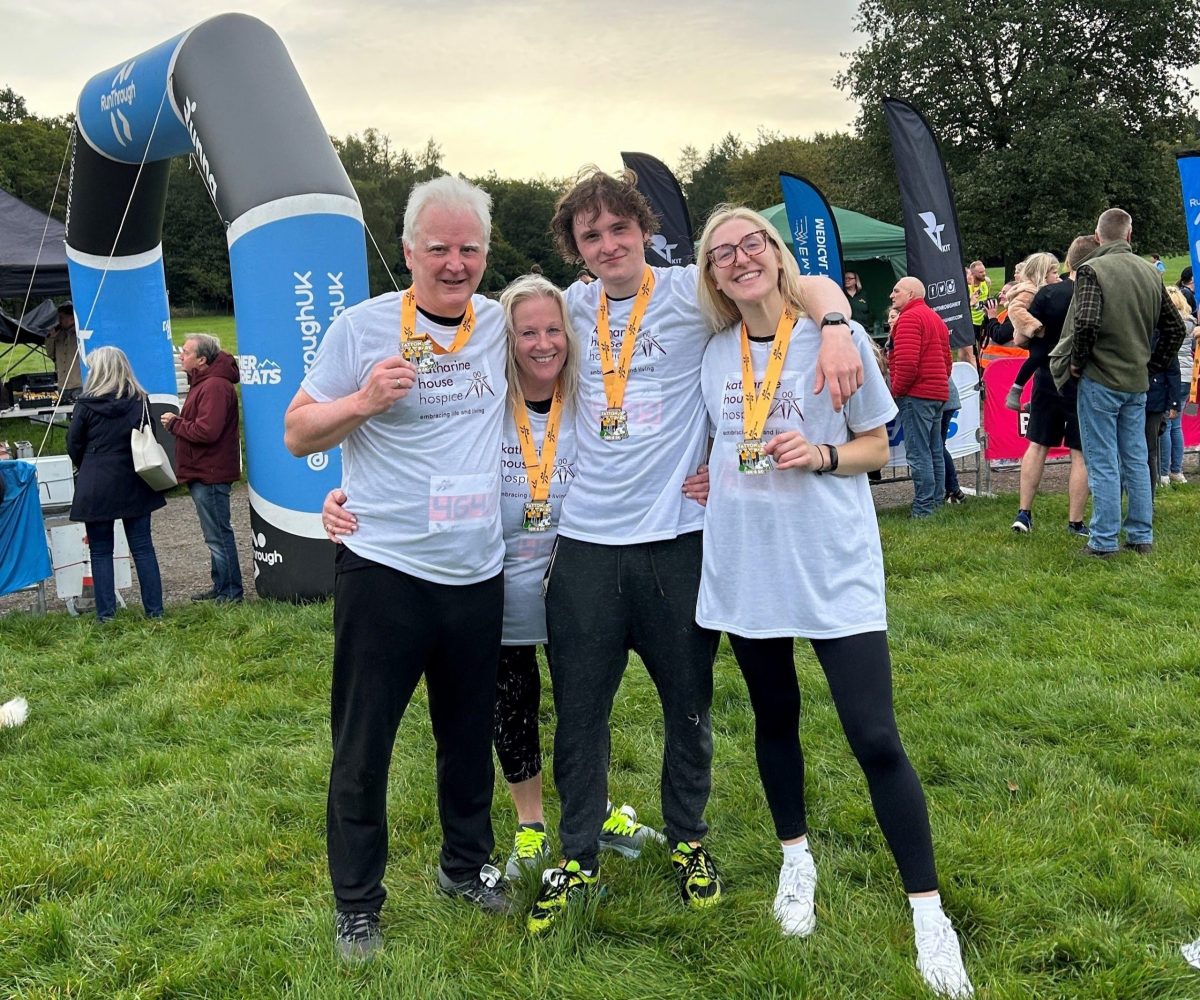 Richard and his family smiling together with their medals after completing the Tatton Park 5K.