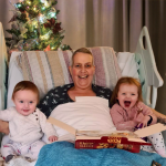 Marie laughs with her young grandchildren on her bed in the hospice.