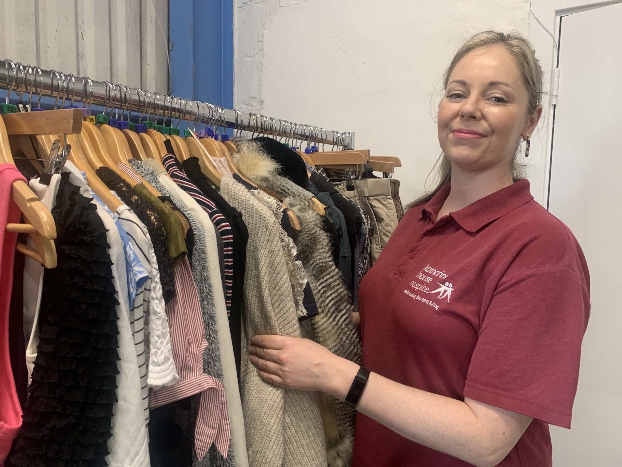 A retail assistant sorts through donations