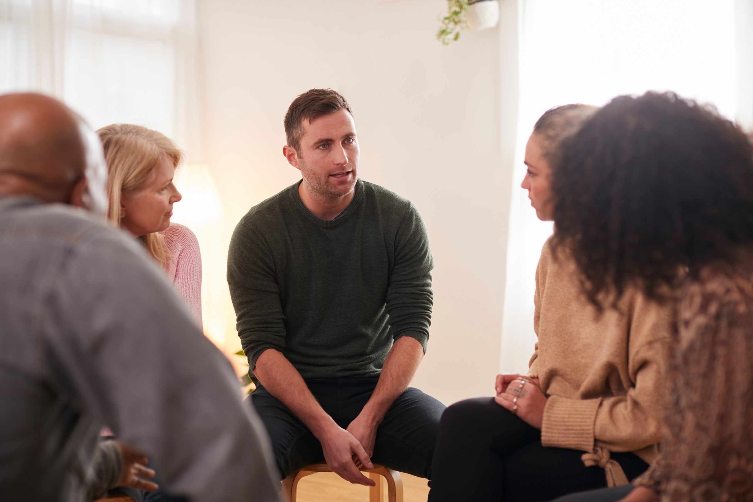 A diverse group of people chatting casually.