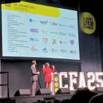 Lisa Snowdon and 'The Great British Sewing Bee's Patrick Grant on stage about to announce the winners of our category. Our logo is among other charities on the large screen.