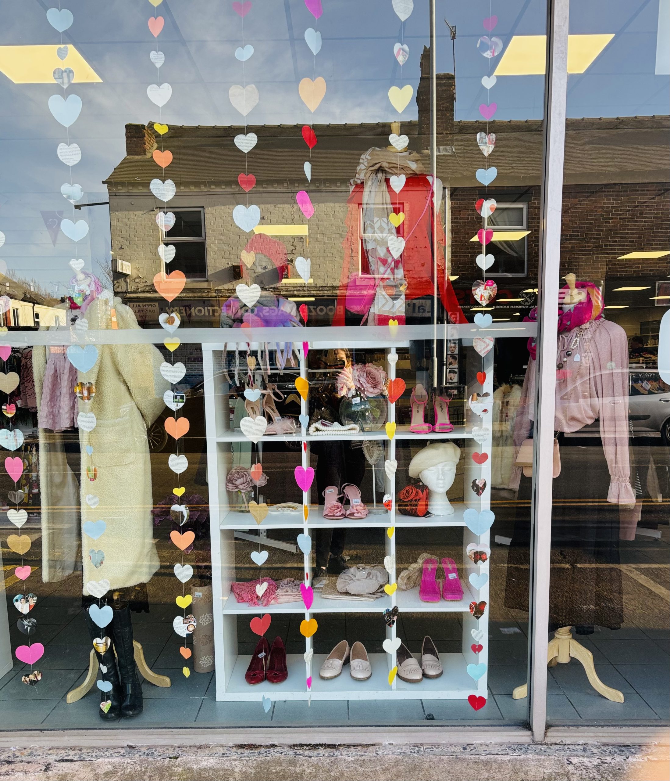IMG_6875 Long threads of hearts hang from the charity shop window.