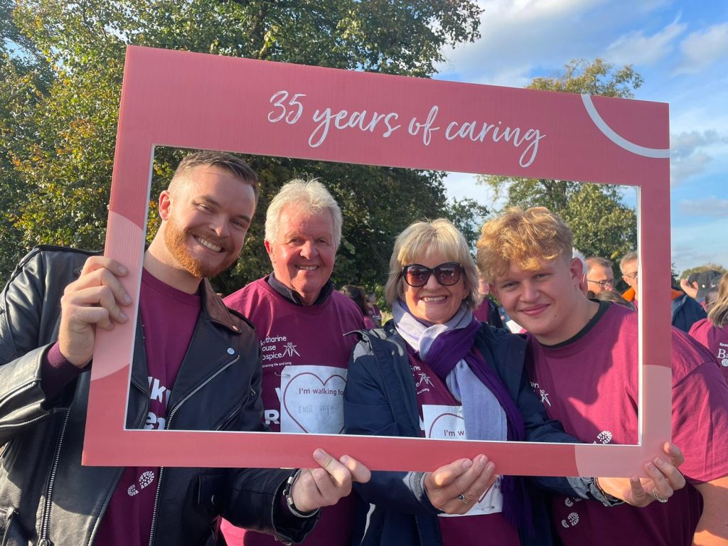Walk to Remember participants pose with a selfie frame 2024