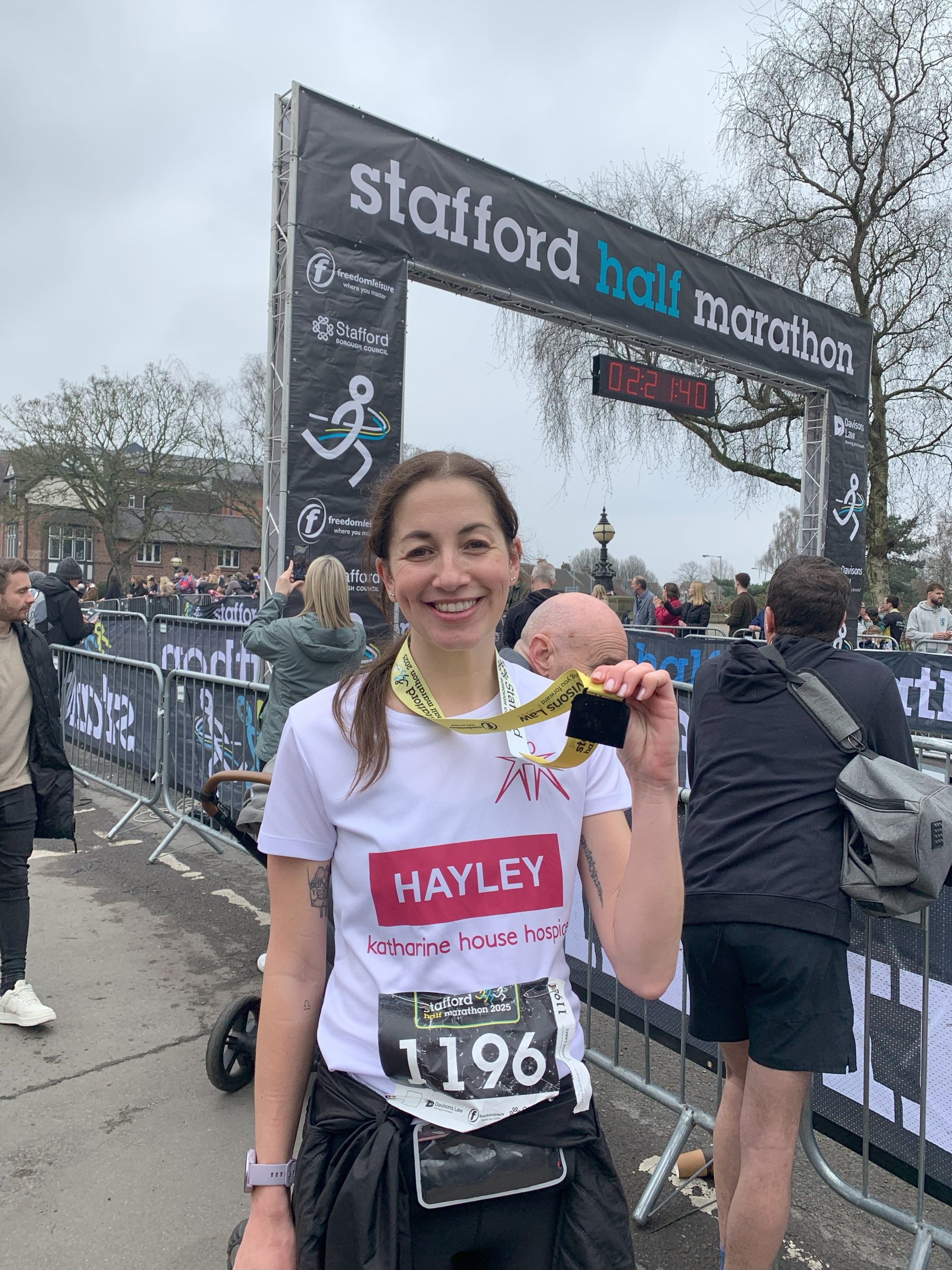 Hayley Amison smiles proudly with her medal at Stafford Half Marathon 2025.