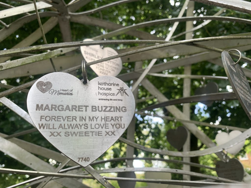 A steel heart shaped tribute engraved with the words Margaret Buzzing forever in my heart will always love you sweetie xx.