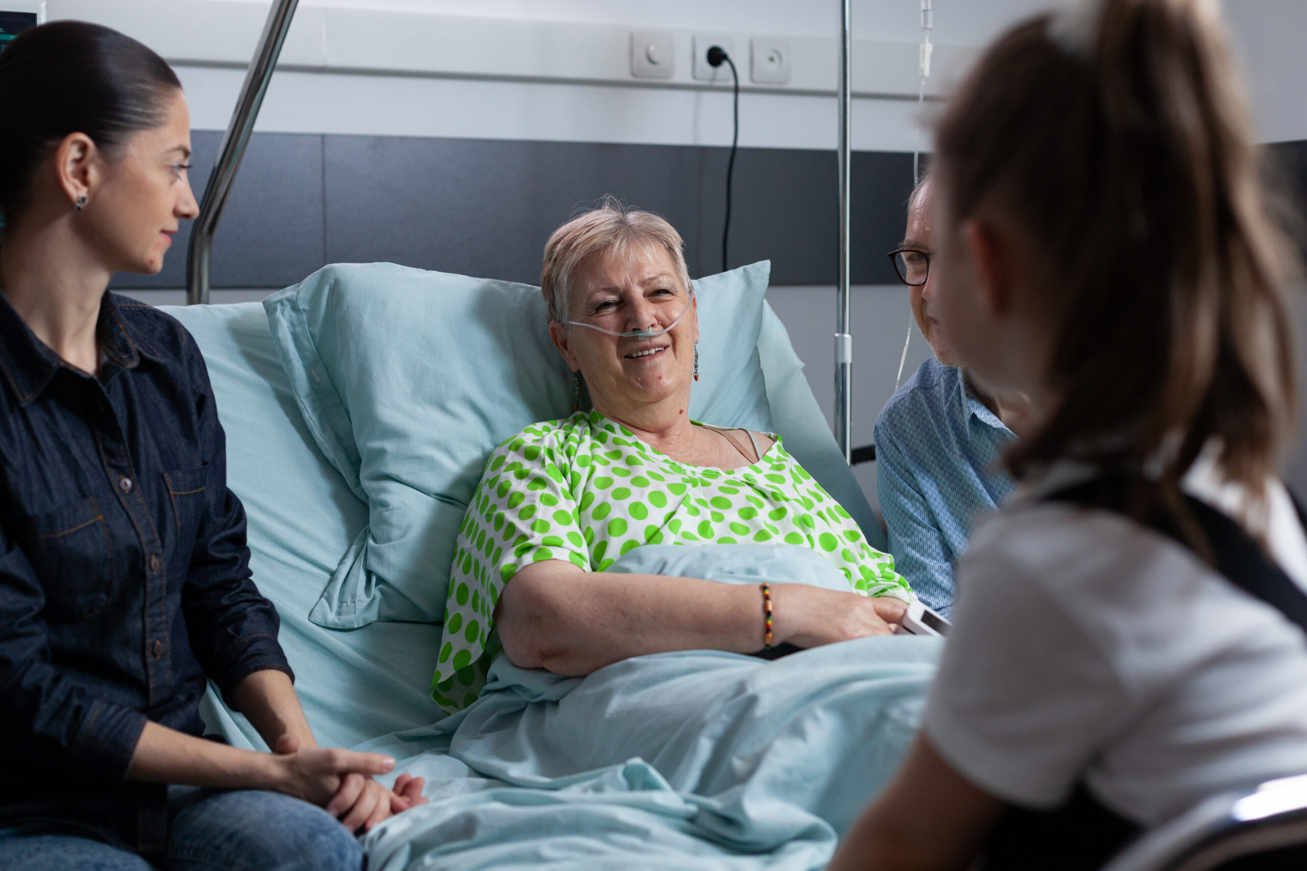 Relatives visiting a lady during an in-patient stay.