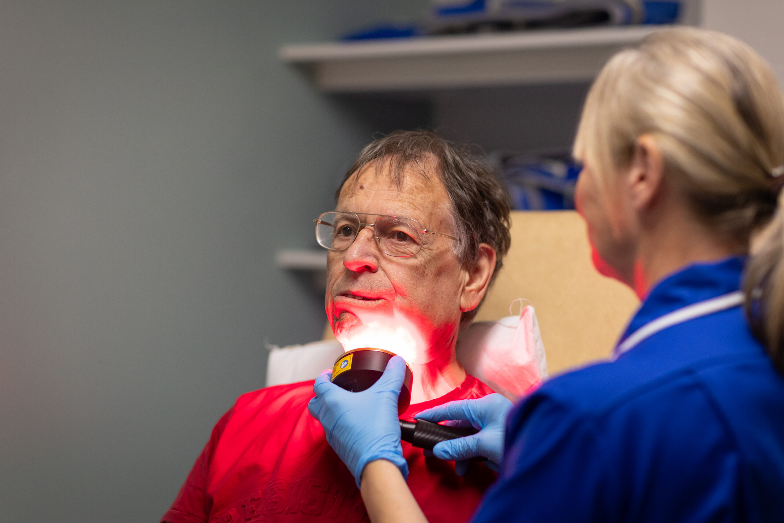 Close up of a man having laser treatment on his face.
