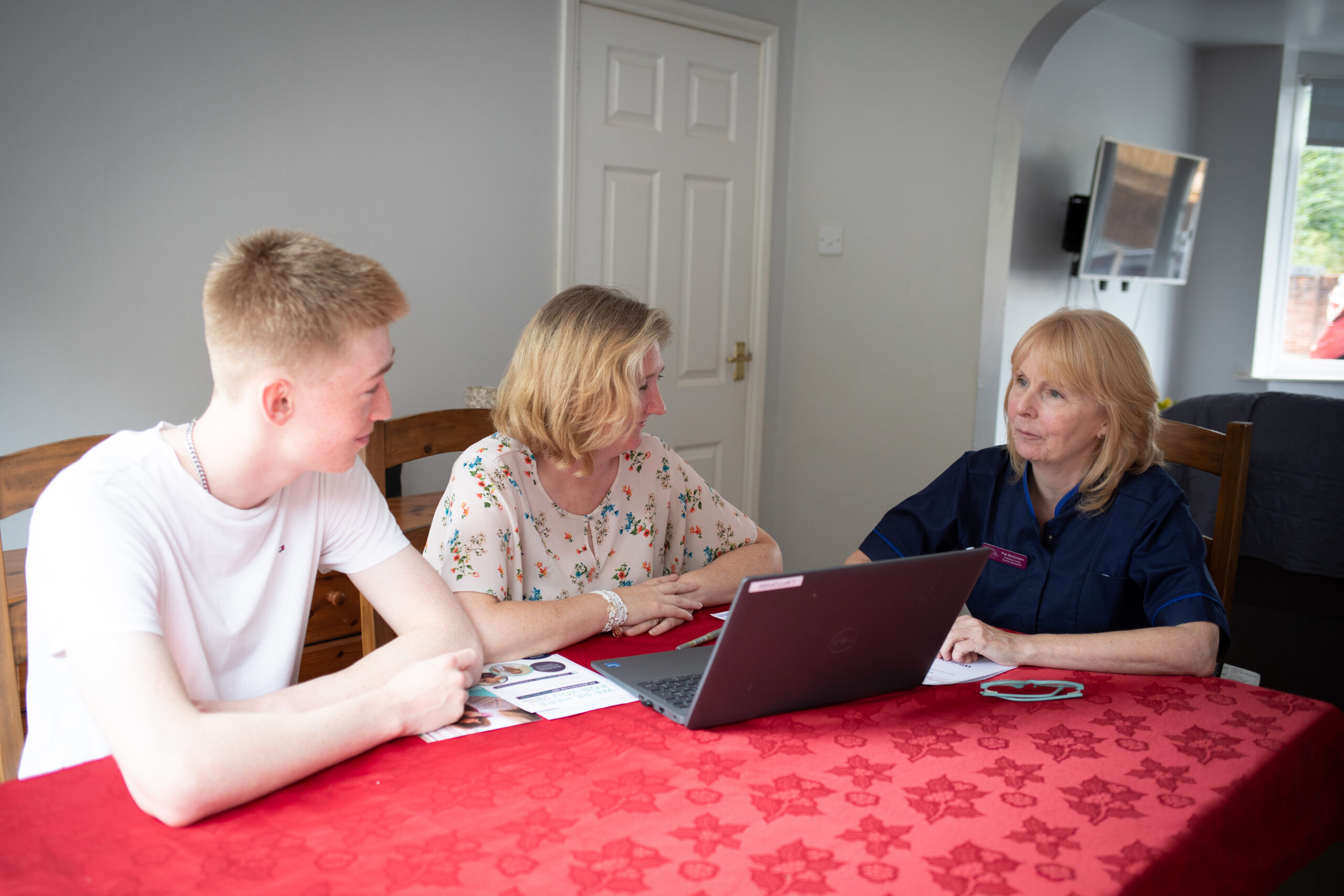 Nurse Maggie speaks to a family in their home.