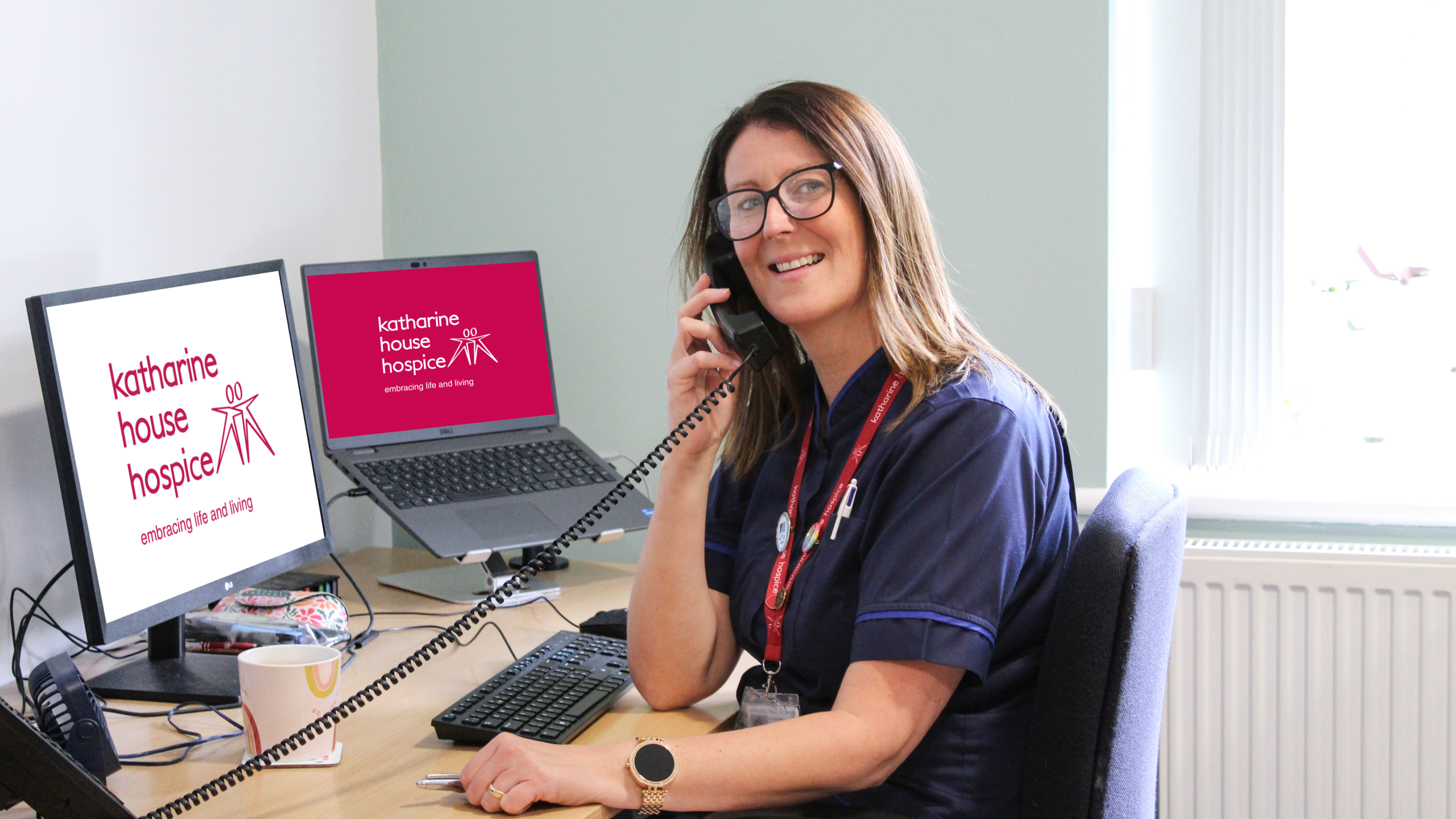 Nurse Clare on the phone, smiling to camera
