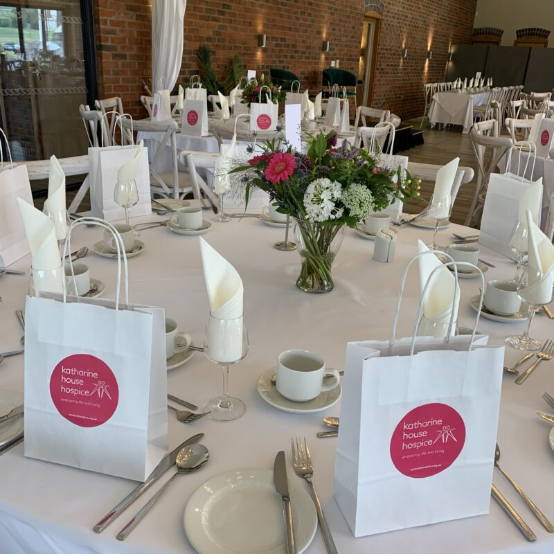 Tables decorated with flowers and goody bags
