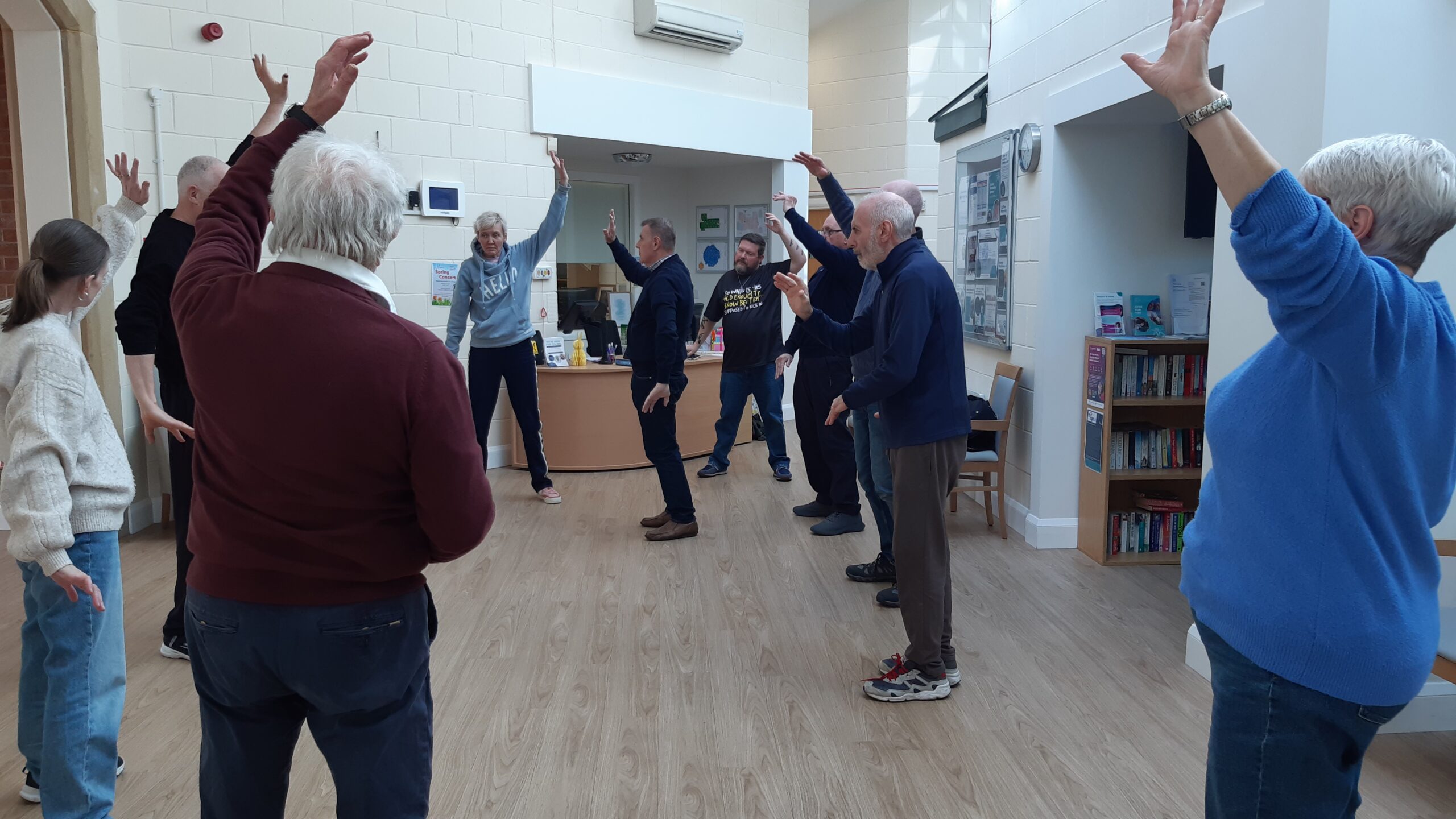 A group of people stretching their arms over their heads