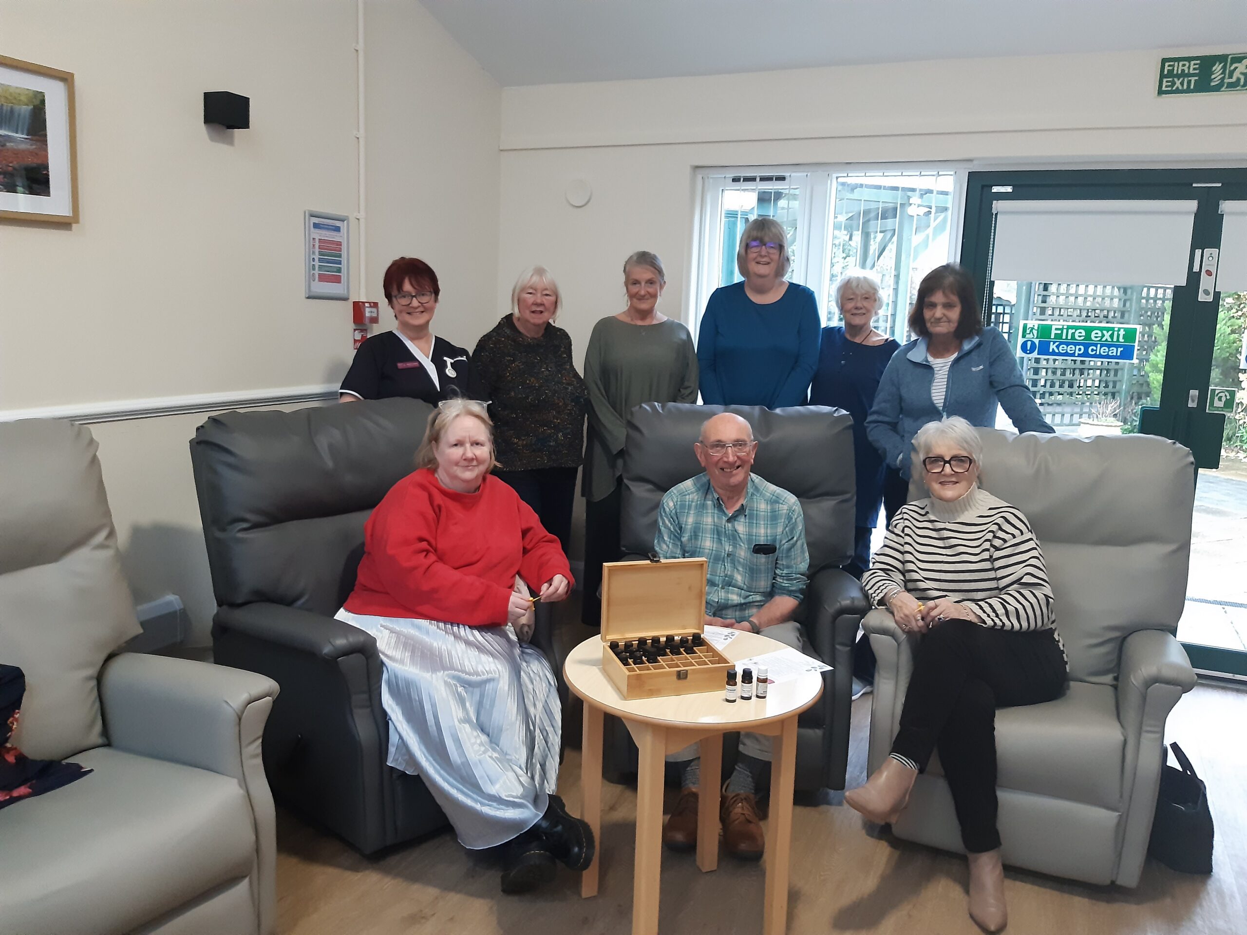 A group photo, gathered around a table of aromatherapy items.