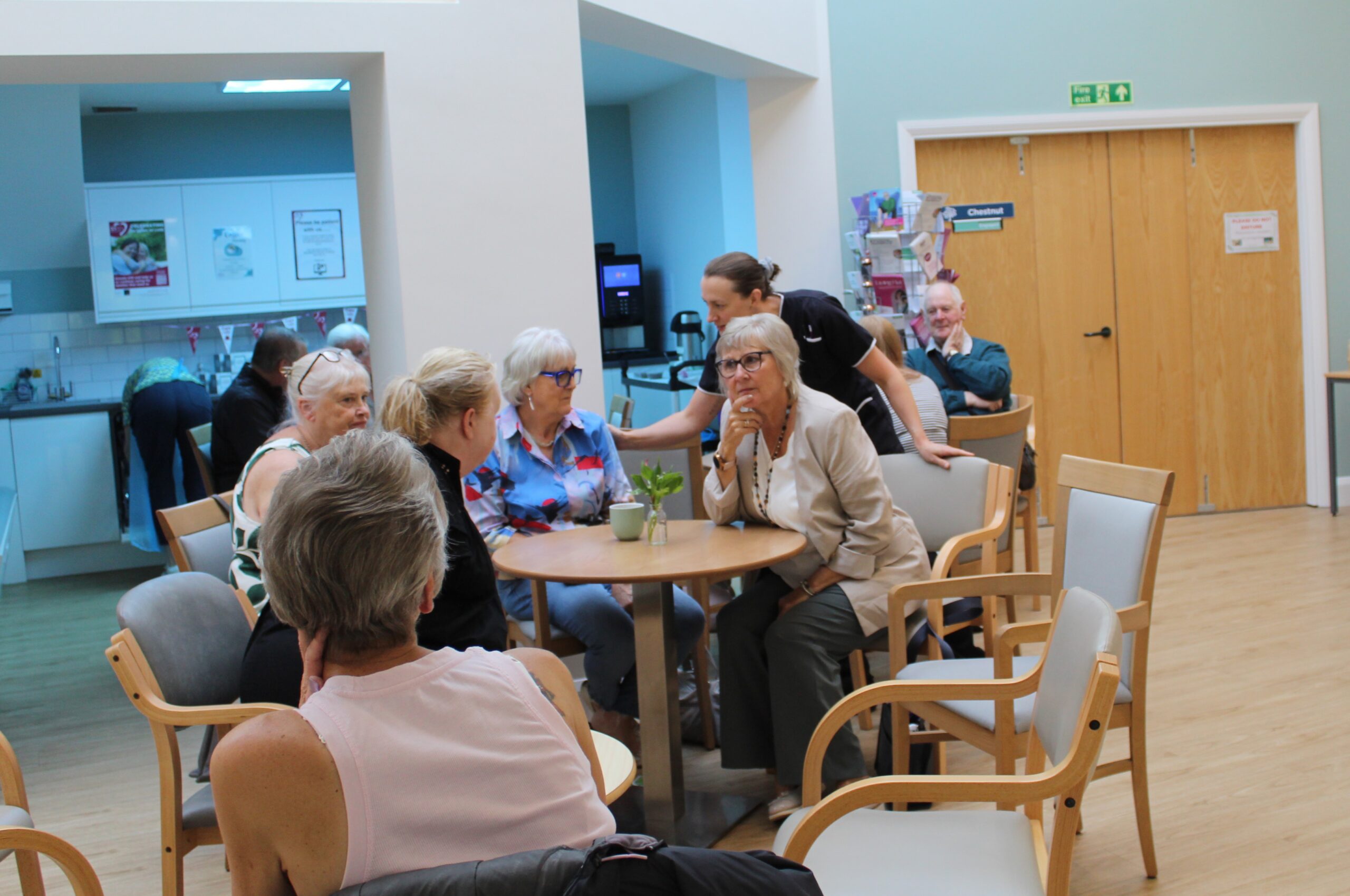 A busy cafe area, people chatting and having a cuppa.