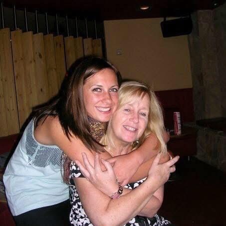 A daughter hugging her mum.
