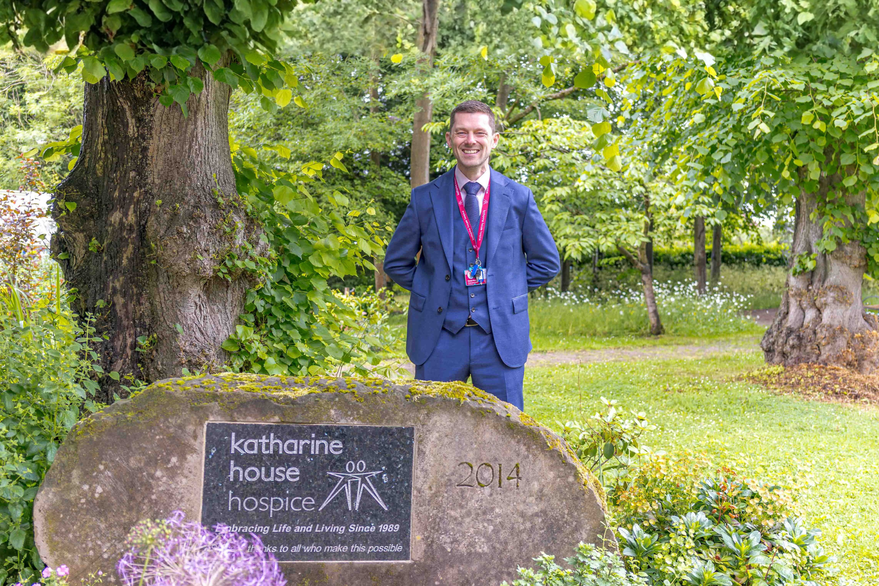 David Fletcher CEO stands in the hospice garden.