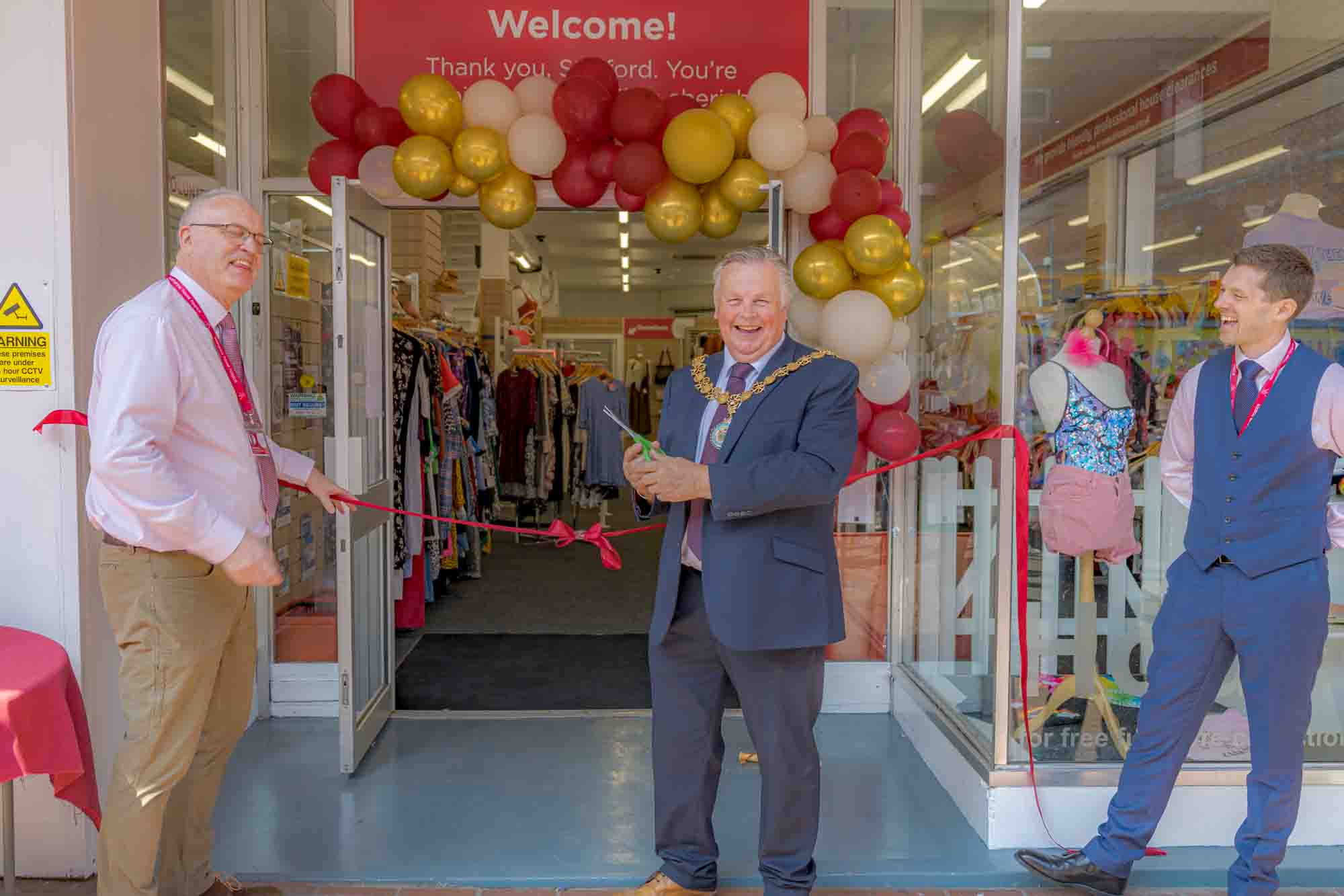 Simon Dodd, Katharine House Retail General Manager with the Mayor of Stafford and David Fletcher, Director of Care as the ribbon is cut to welcome people back into the refurbished store