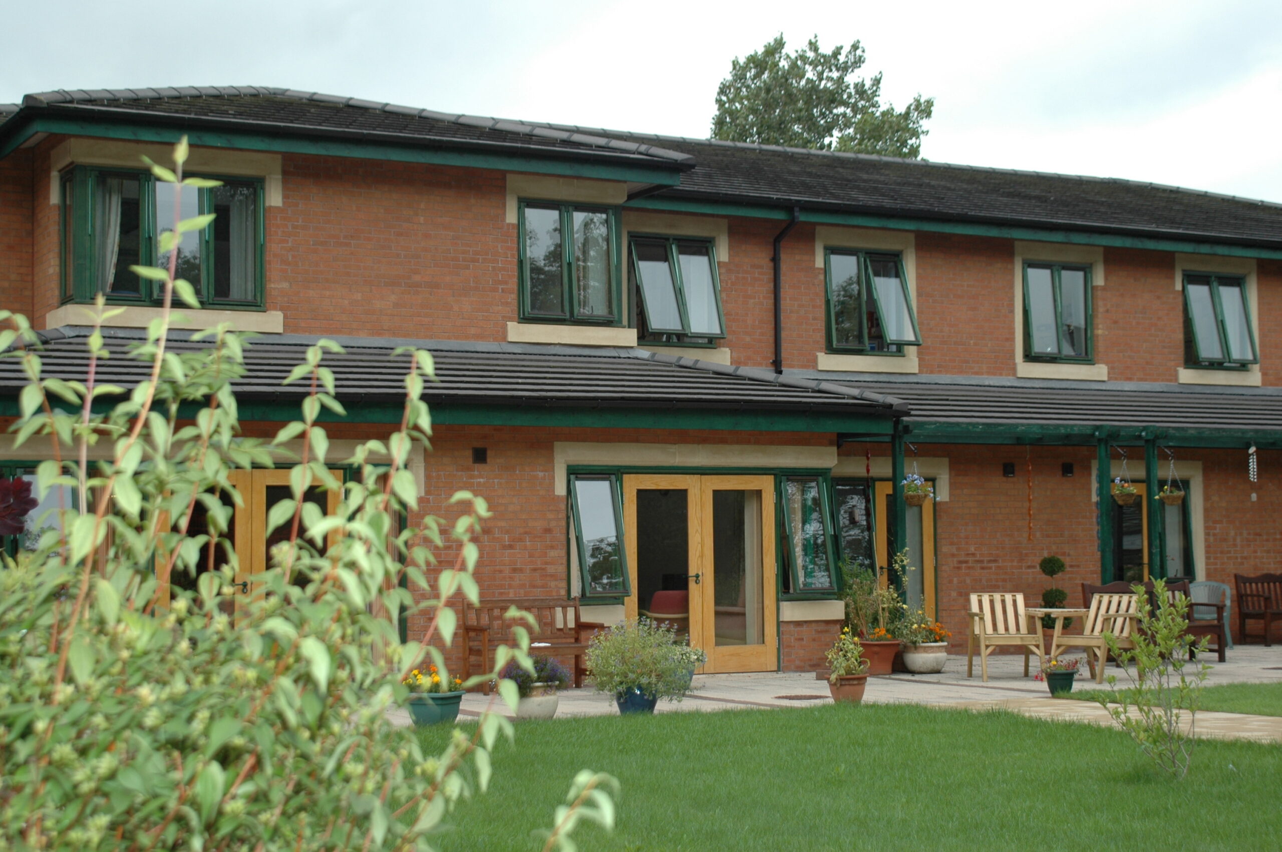 A two storey brick building with windows and glass doors