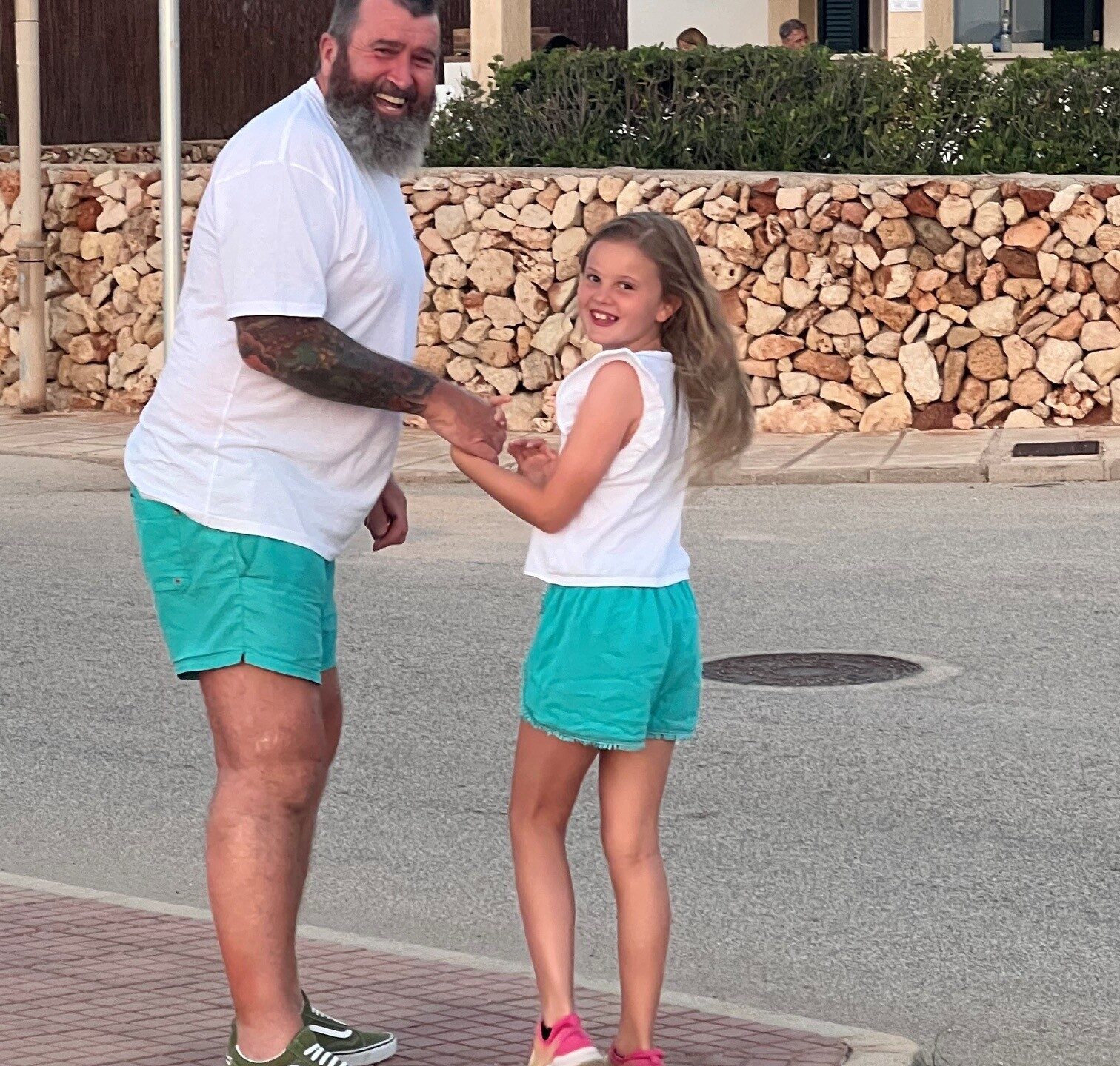 Father and young daughter in matching outfits.
