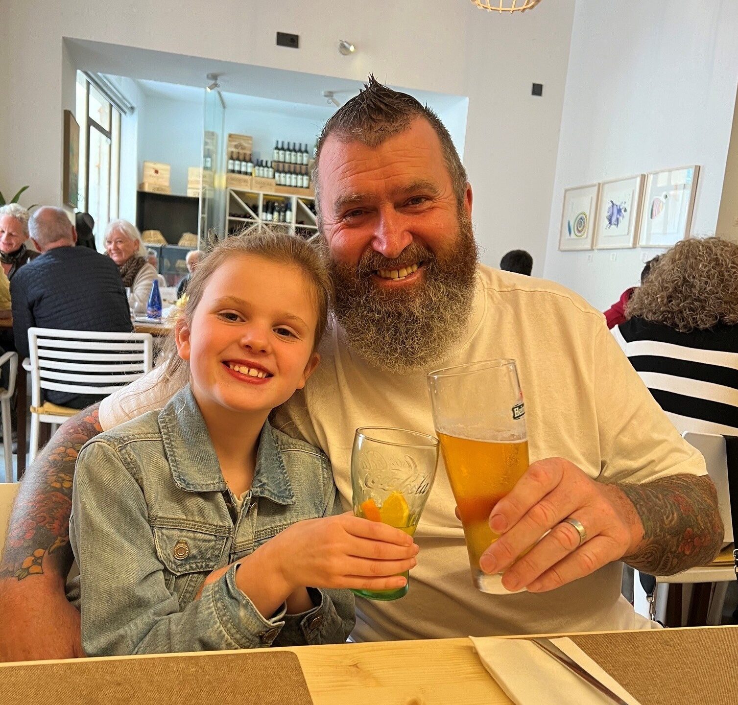 Older man with young girl sitting together on a night out.