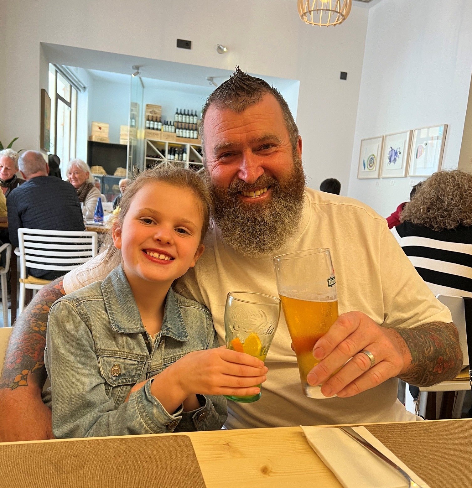 Older man with young girl sitting together on a night out.