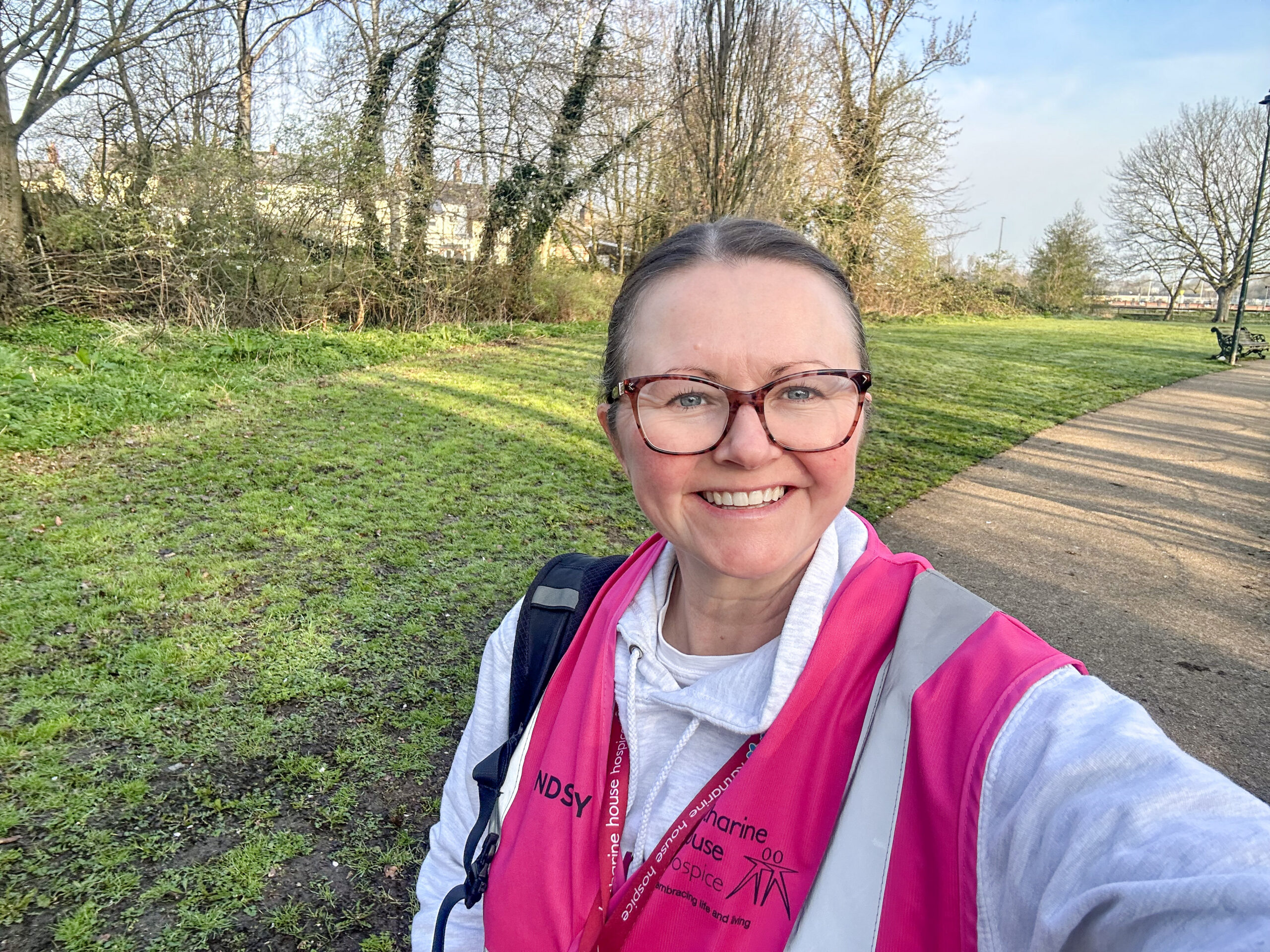 Selfie of Lyndsey, wearing a pink Katharine House Hospice hi-vis event jacket.