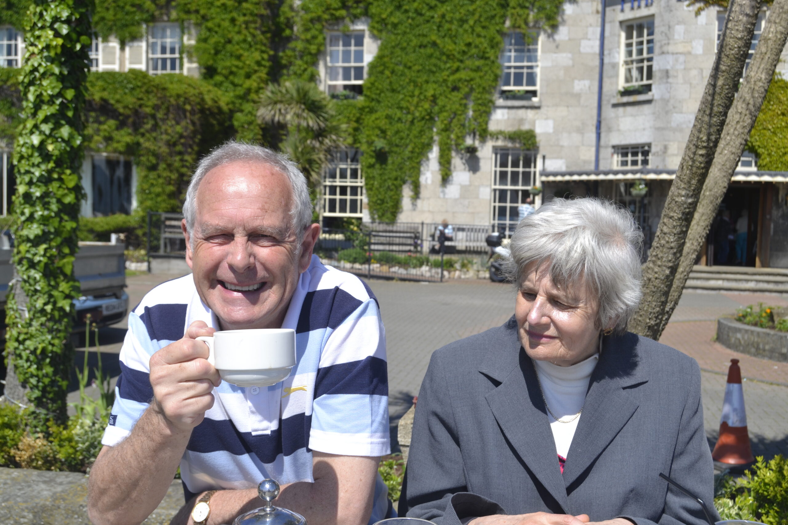 Jean and Don enjoying a cuppa in the sunshine on holiday
